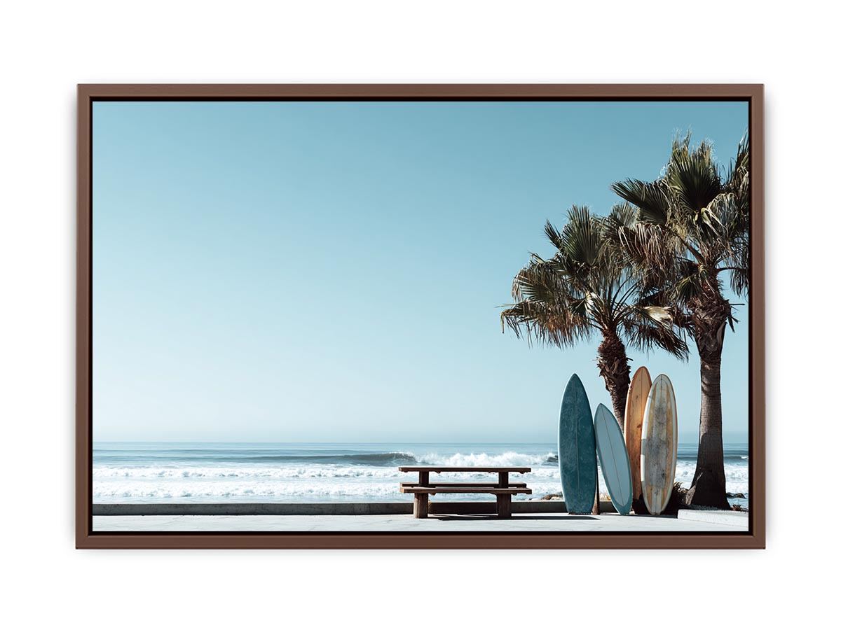 Surfboards and palm trees beside the ocean in coastal modern beach house decor