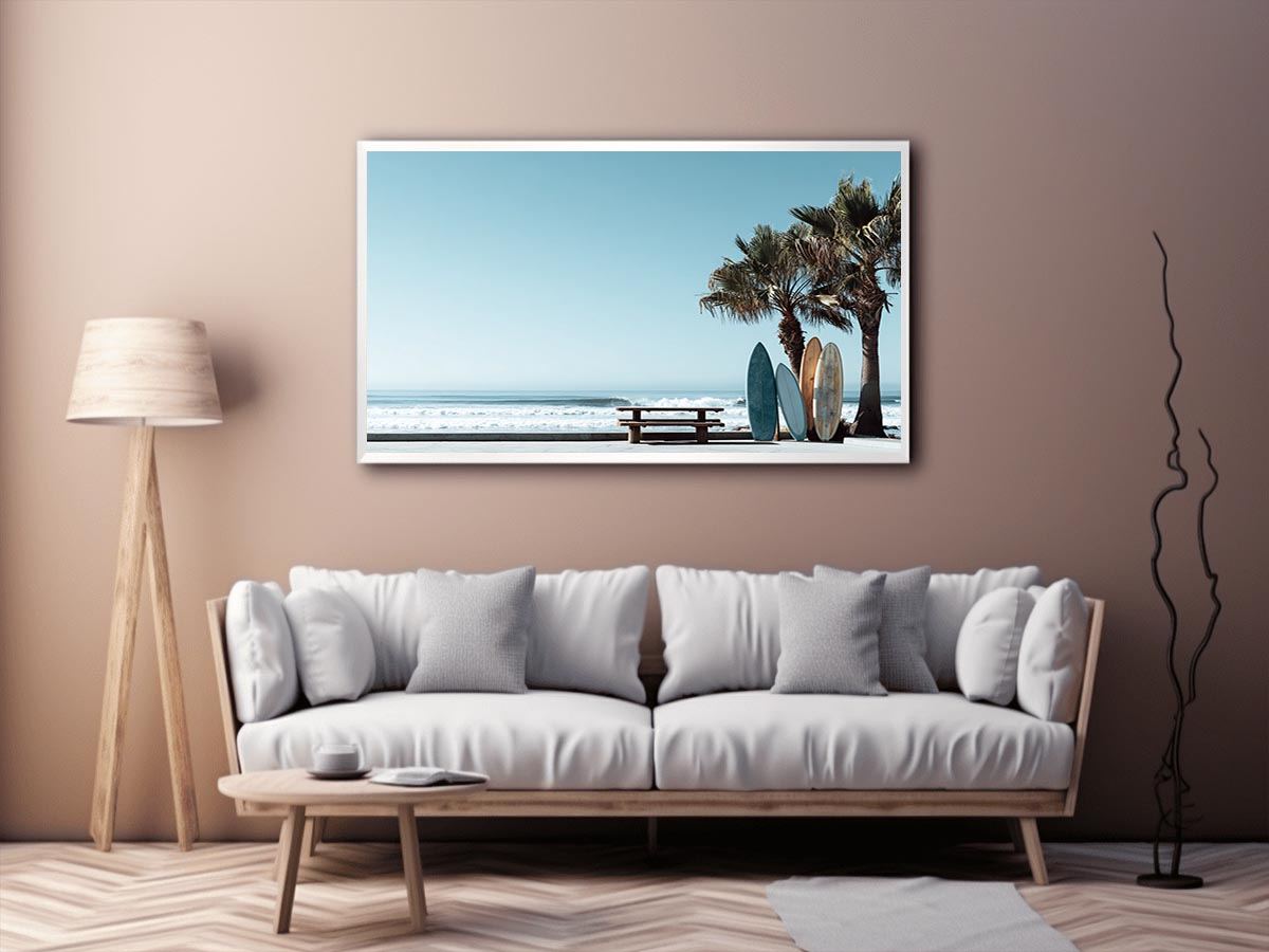 Surfboards and palm trees beside the ocean in coastal modern beach house decor