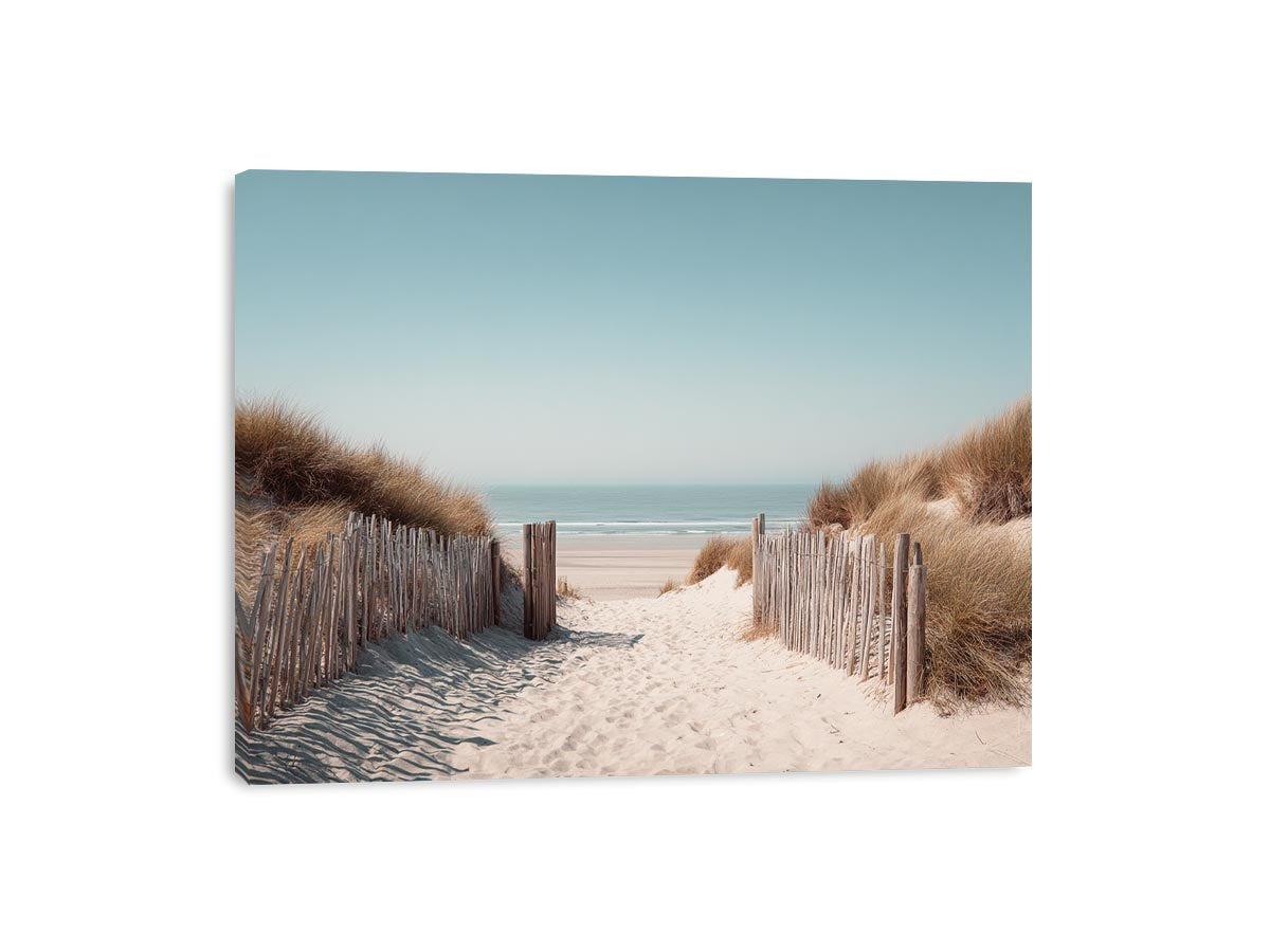 Sandy dune pathway leading to the ocean in minimalist coastal decor