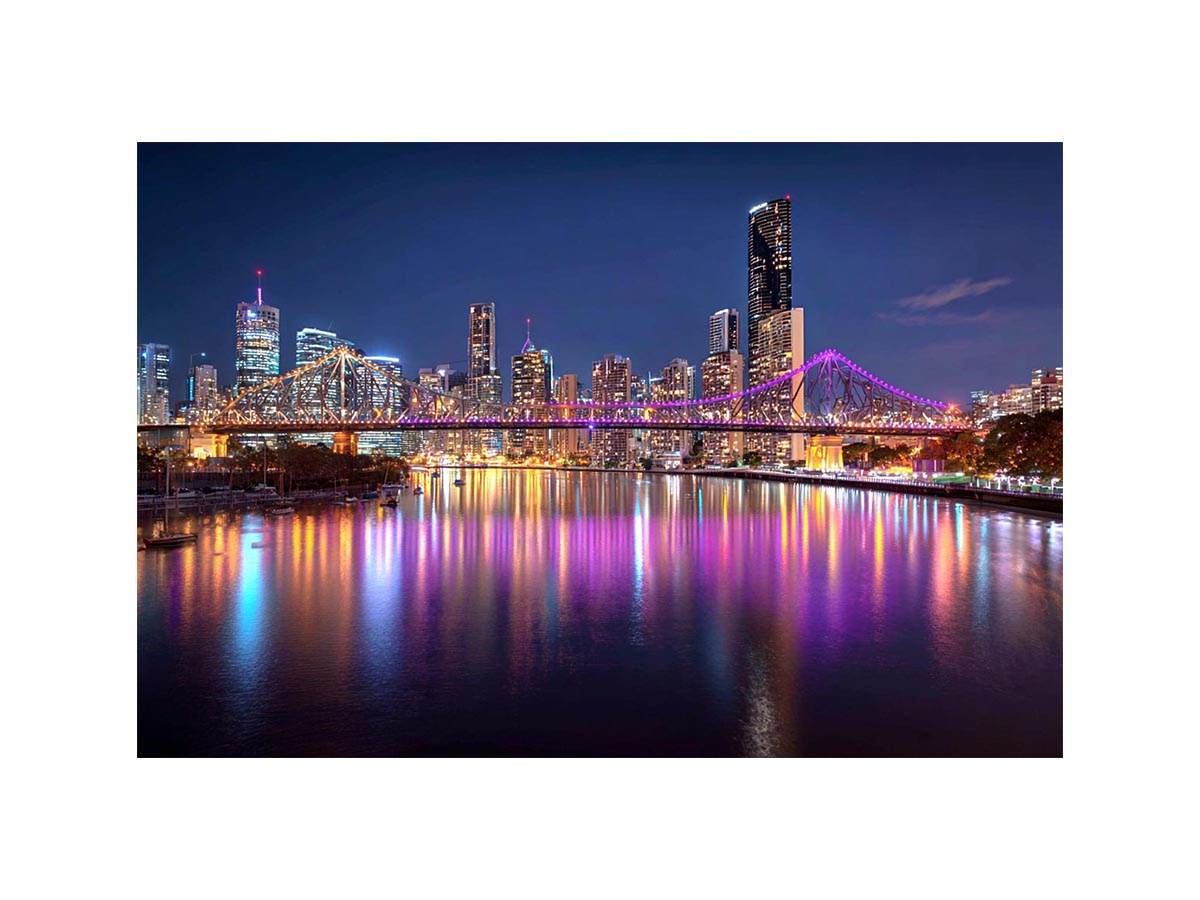 Illuminated bridge and city skyline canvas art for contemporary living room decor.