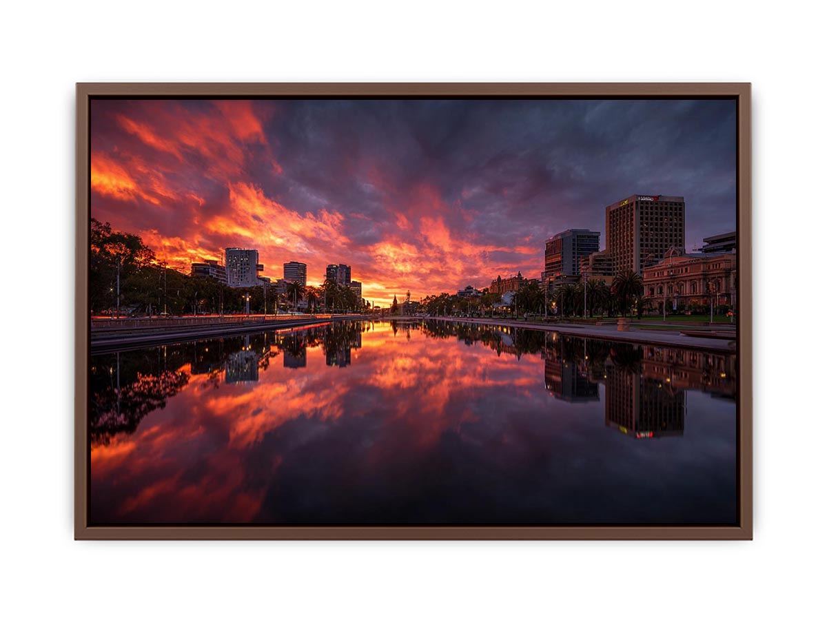 Dramatic city skyline canvas art with fiery sunset reflections for modern decor.