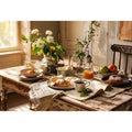 Rustic farmhouse breakfast table wall art with pastries coffee flowers and cozy natural morning light interior scene
