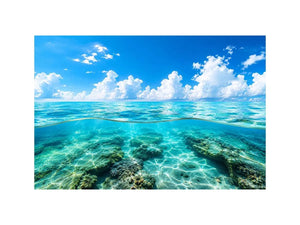 Bright split-view ocean wall art featuring crystal-clear turquoise water, underwater rock formations, and soft clouds beneath a vivid blue sky.