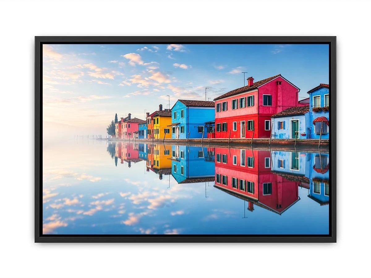 Bright colorful coastal village wall art featuring vibrant European houses reflected in calm water with soft fog and minimalist atmospheric tones.