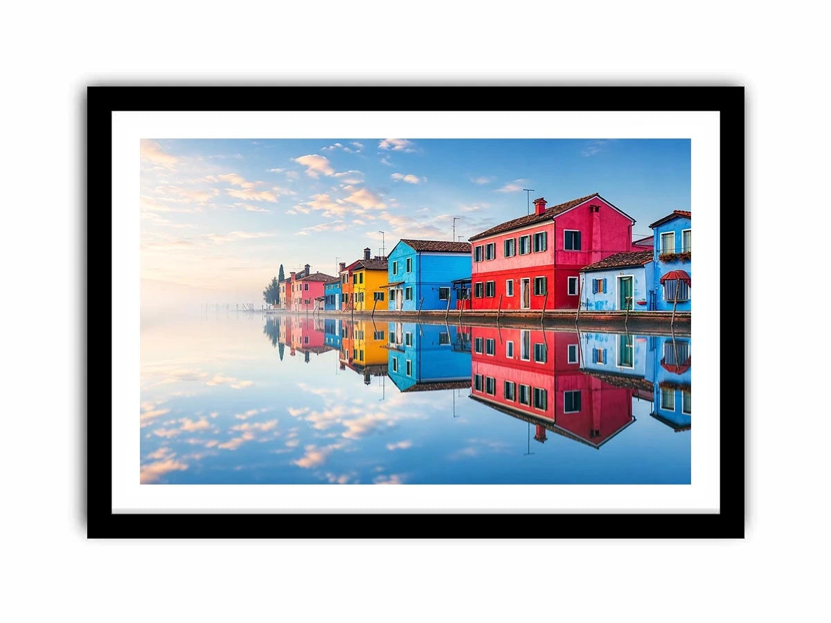 Bright colorful coastal village wall art featuring vibrant European houses reflected in calm water with soft fog and minimalist atmospheric tones.