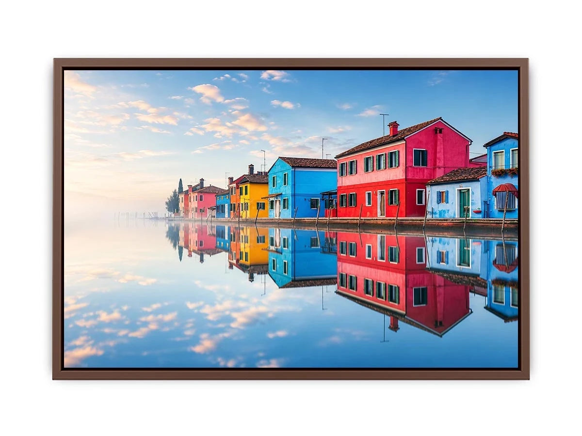 Bright colorful coastal village wall art featuring vibrant European houses reflected in calm water with soft fog and minimalist atmospheric tones.