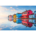 Bright colorful coastal village wall art featuring vibrant European houses reflected in calm water with soft fog and minimalist atmospheric tones.