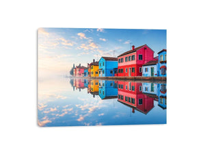 Bright colorful coastal village wall art featuring vibrant European houses reflected in calm water with soft fog and minimalist atmospheric tones.