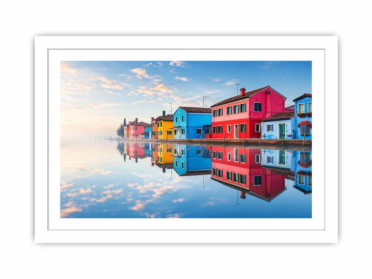 Bright colorful coastal village wall art featuring vibrant European houses reflected in calm water with soft fog and minimalist atmospheric tones.