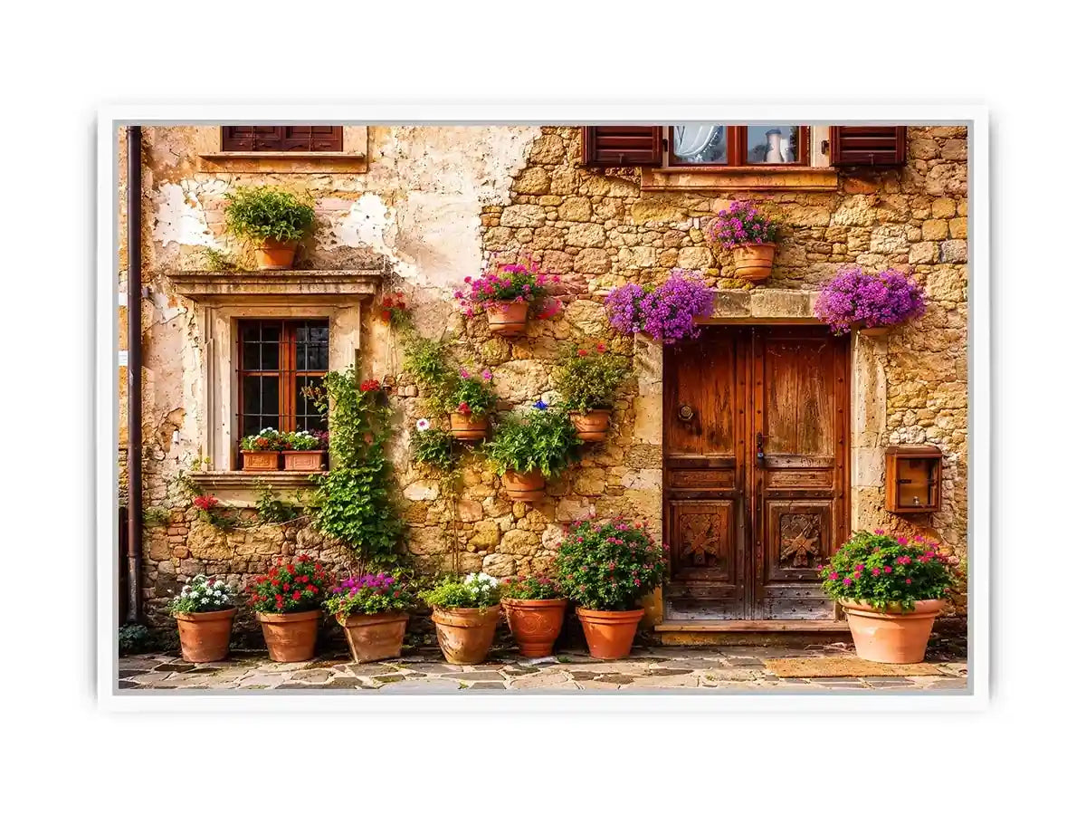Rustic Mediterranean stone house facade with pink flowers and vintage wooden doors wall art canvas for luxury living room decor