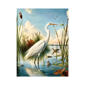 Vintage white heron standing in tranquil marshland with soft blue sky and reeds coastal bird wall art canvas