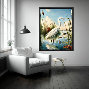Vintage white heron standing in tranquil marshland with soft blue sky and reeds coastal bird wall art canvas
