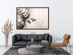 Minimalist coastal boat wall art with small rowboats beside rocky shoreline in monochrome sketch style