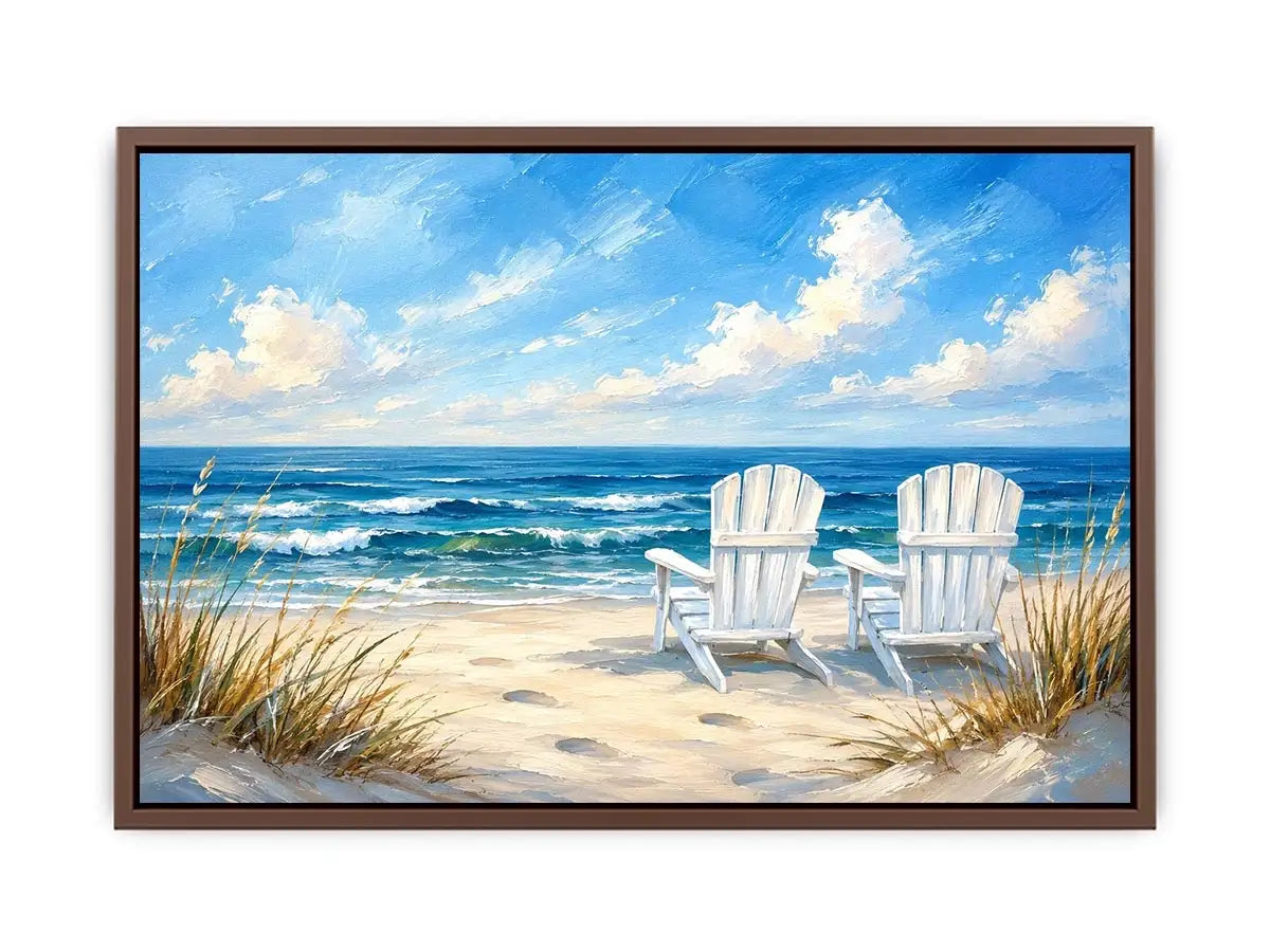 White beach chairs overlooking calm ocean waves on a sandy coastal shoreline