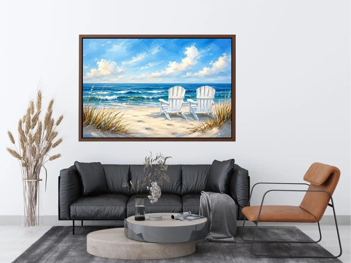 White beach chairs overlooking calm ocean waves on a sandy coastal shoreline