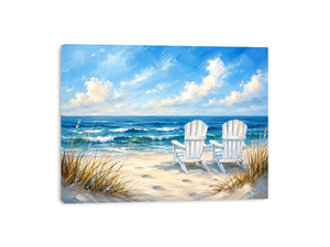 White beach chairs overlooking calm ocean waves on a sandy coastal shoreline