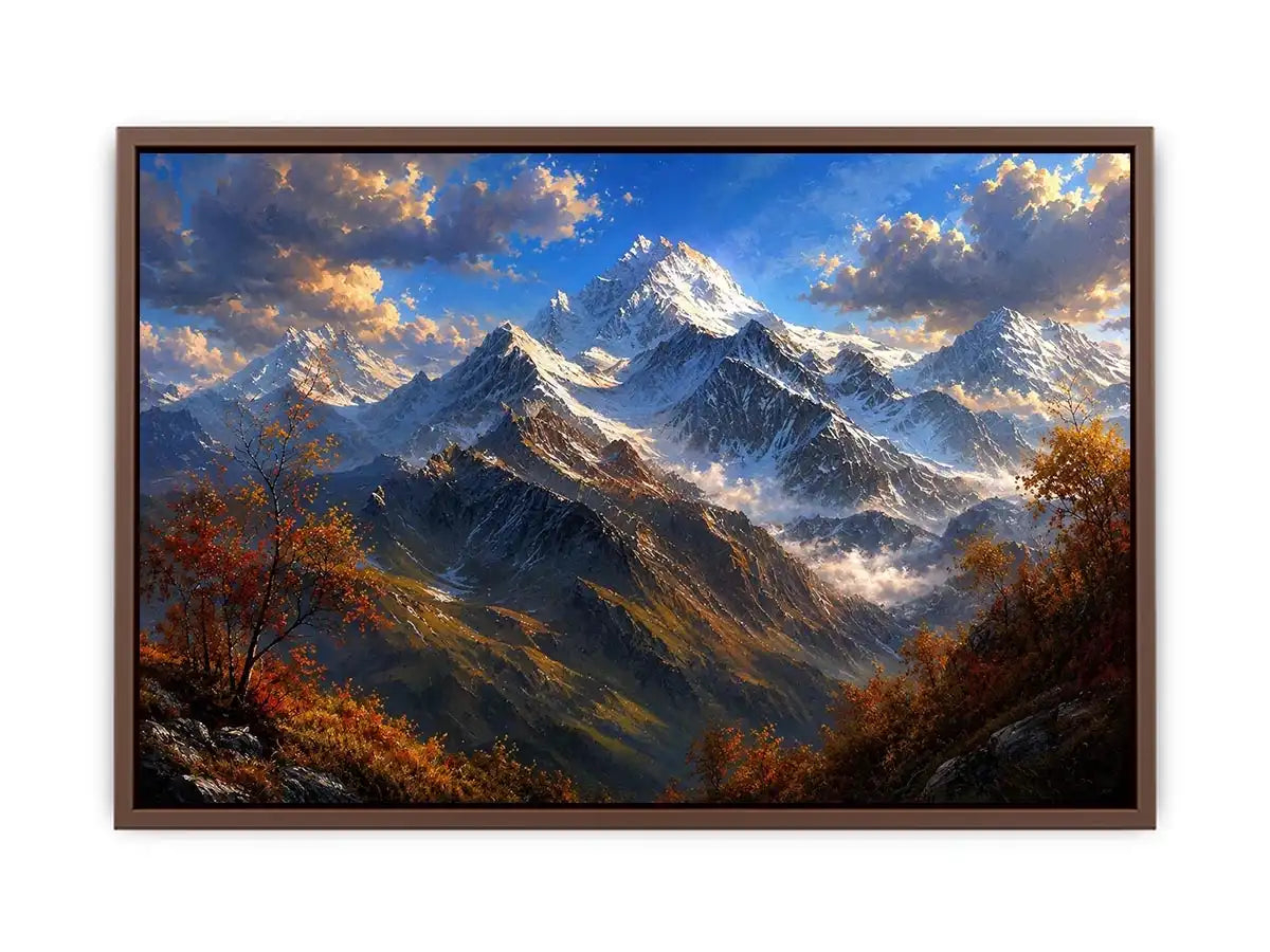 Majestic snow-covered mountain peaks with autumn trees beneath a dramatic blue sky