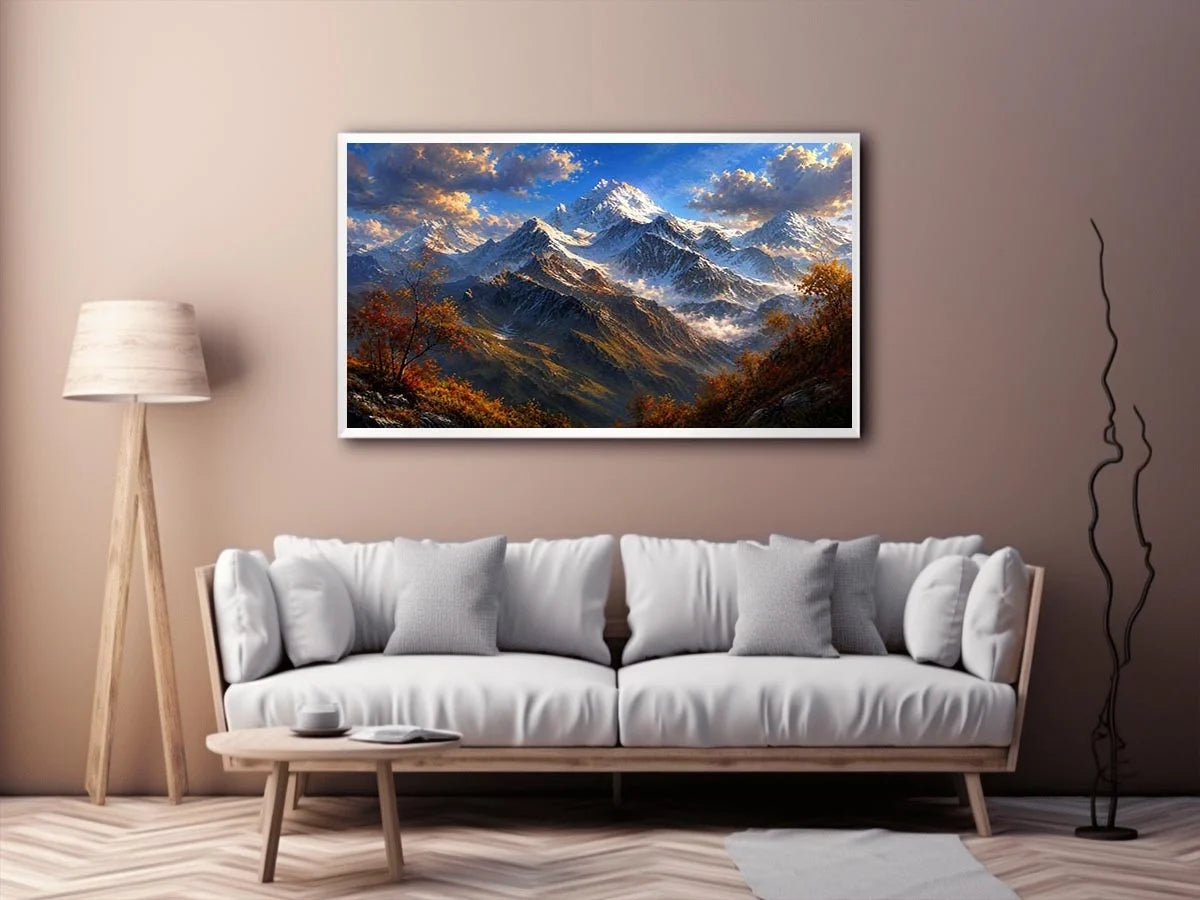Majestic snow-covered mountain peaks with autumn trees beneath a dramatic blue sky