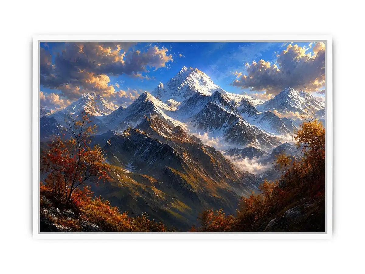 Majestic snow-covered mountain peaks with autumn trees beneath a dramatic blue sky