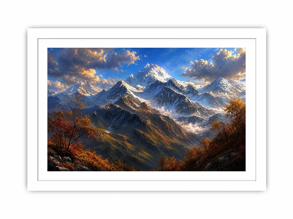 Majestic snow-covered mountain peaks with autumn trees beneath a dramatic blue sky