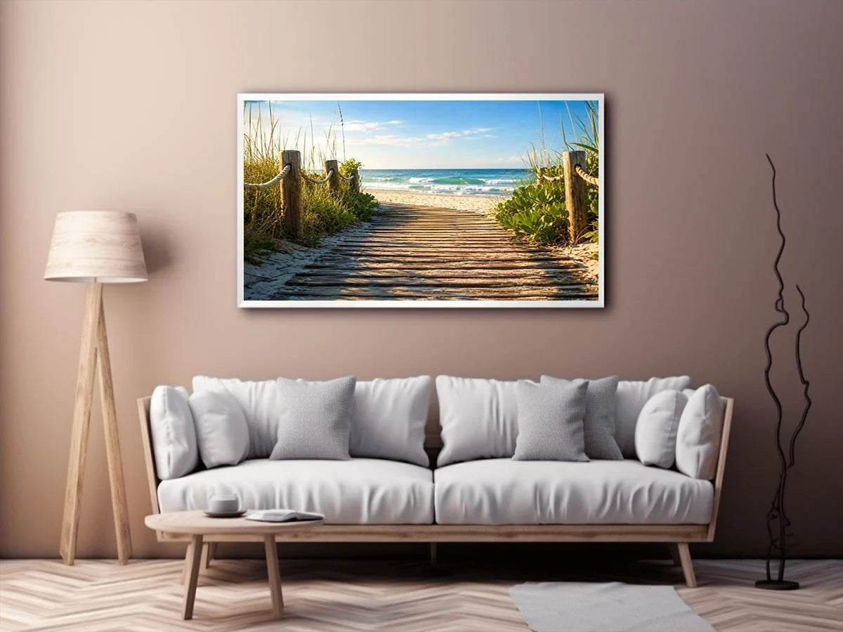 Wooden beach boardwalk leading through coastal dunes toward the ocean shoreline