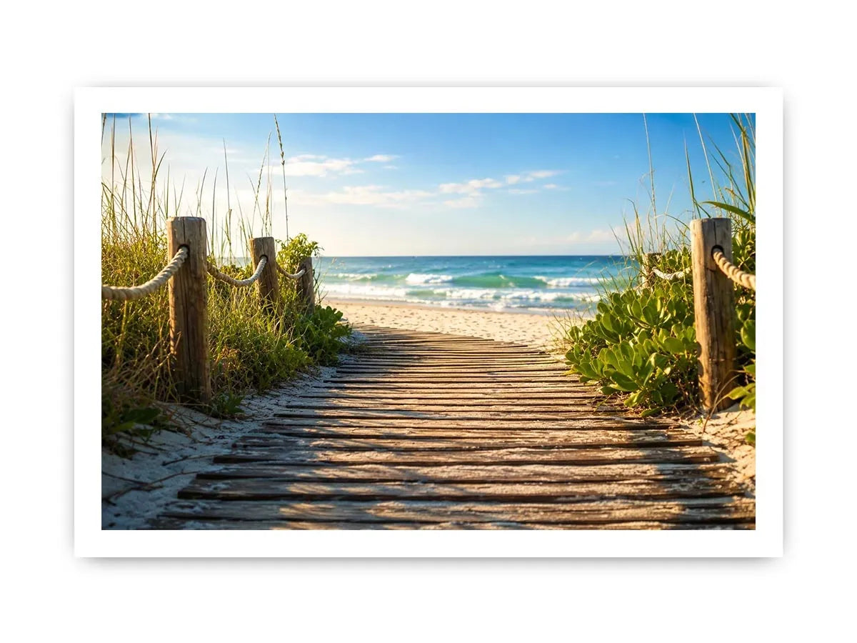 Wooden beach boardwalk leading through coastal dunes toward the ocean shoreline