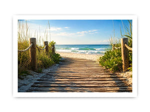 Wooden beach boardwalk leading through coastal dunes toward the ocean shoreline