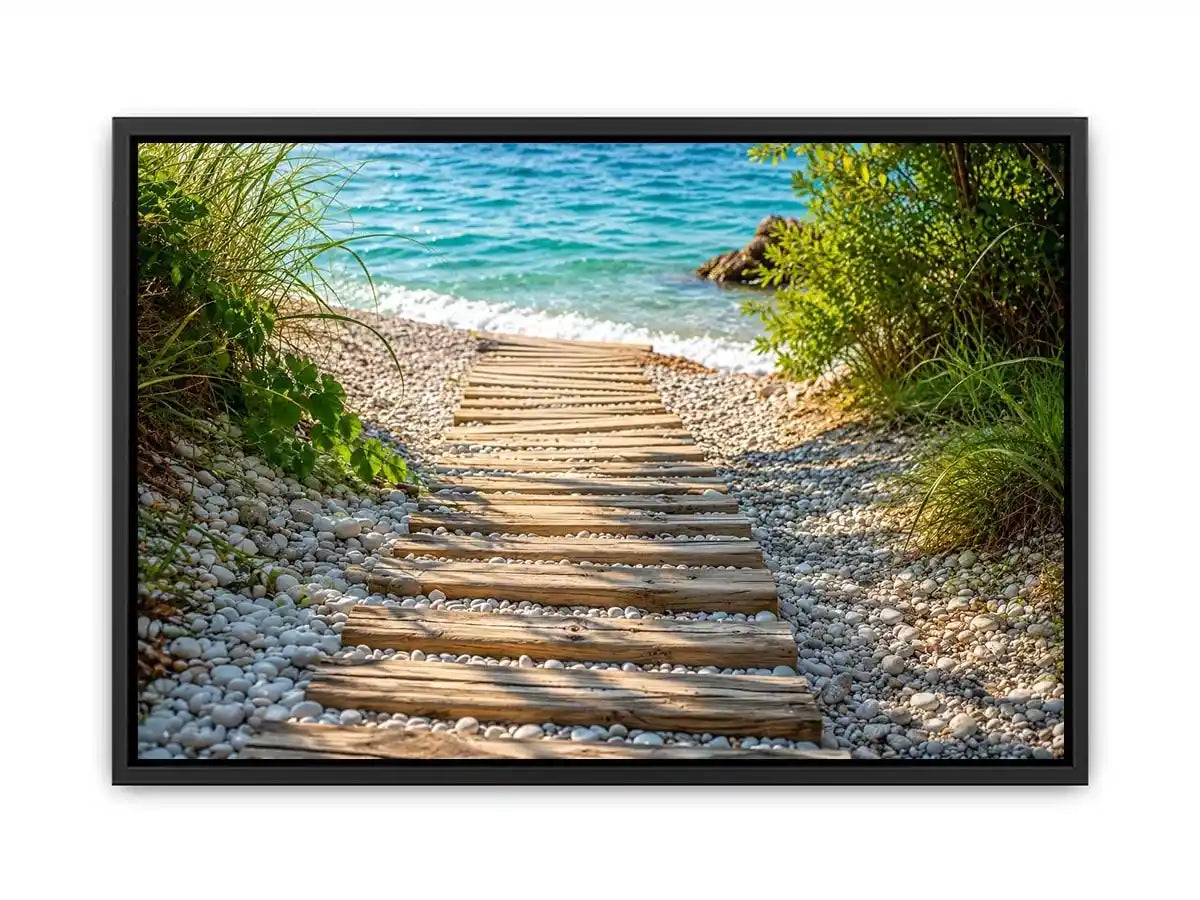 Rustic wooden pathway leading across a pebble beach toward turquoise ocean waves