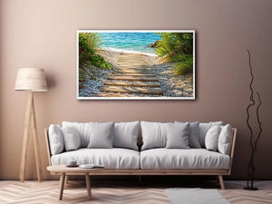 Rustic wooden pathway leading across a pebble beach toward turquoise ocean waves