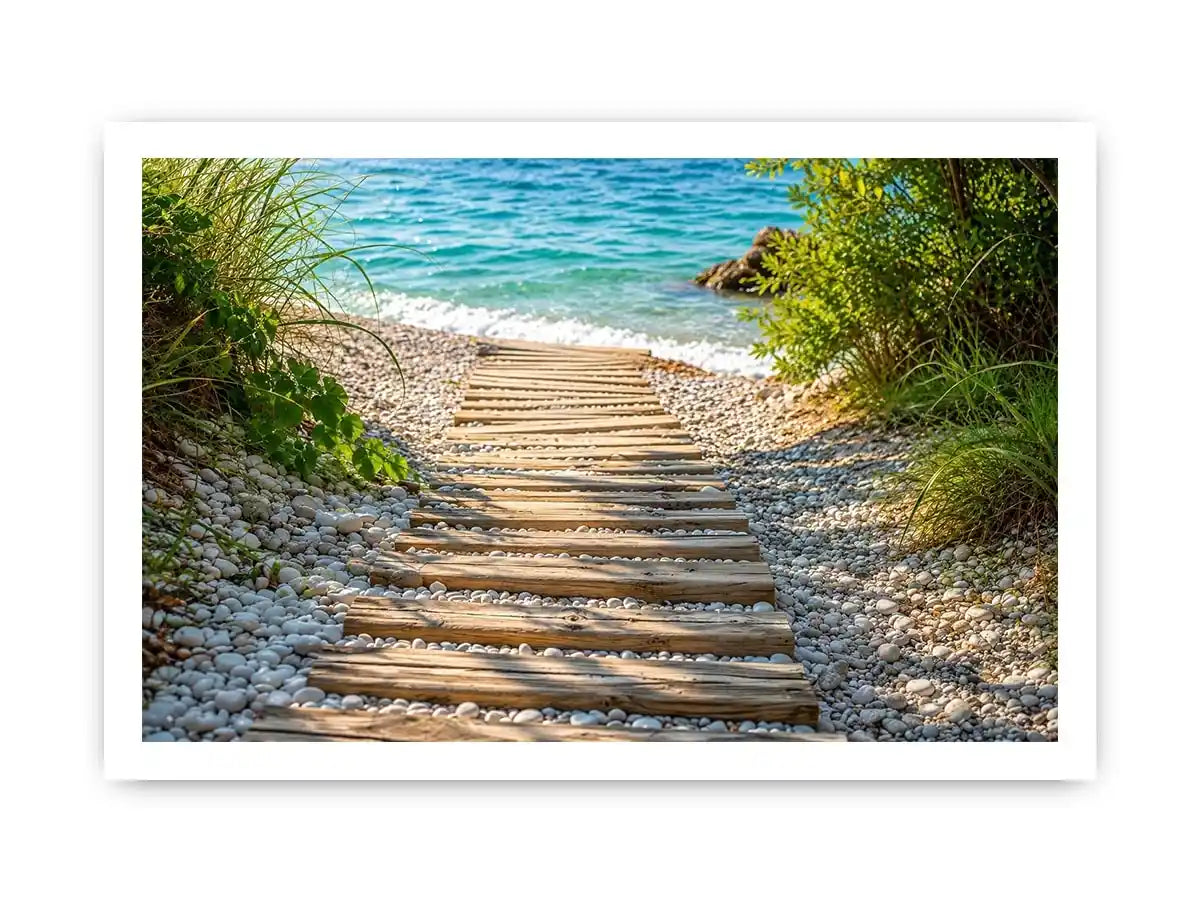 Rustic wooden pathway leading across a pebble beach toward turquoise ocean waves