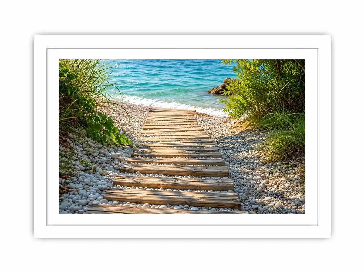 Rustic wooden pathway leading across a pebble beach toward turquoise ocean waves