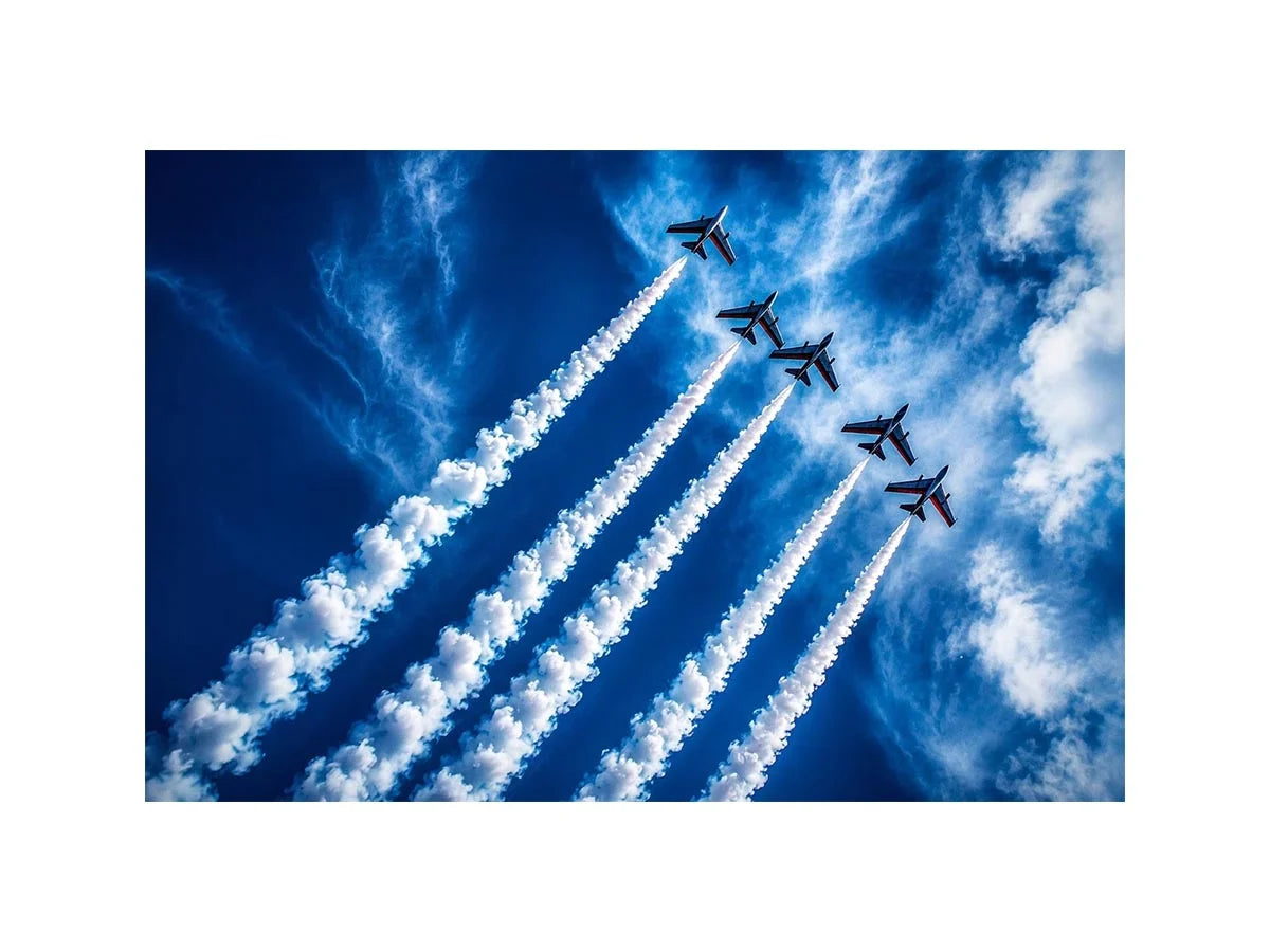 Modern aviation wall art featuring jet planes flying in formation with dramatic smoke trails across deep blue sky in dynamic photography style
