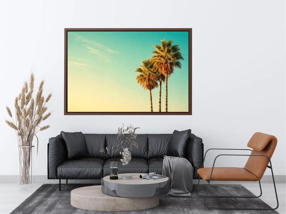 Tall tropical palm trees against soft pastel sky