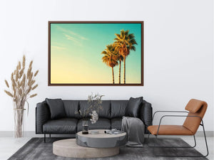 Tall tropical palm trees against soft pastel sky