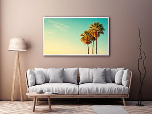 Tall tropical palm trees against soft pastel sky