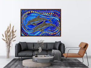 Blue and gold dolphin dot art painting featuring two dolphins swimming through vibrant abstract ocean waves