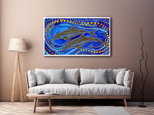 Blue and gold dolphin dot art painting featuring two dolphins swimming through vibrant abstract ocean waves