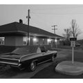 Black and white classic car photo with roadside building for office decor.