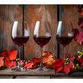Three red wine glasses with autumn leaves and grapes for dining room decor.