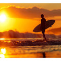 Surfer silhouette wall art with golden sunset and ocean waves for coastal bedroom decor.