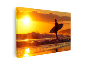 Surfer silhouette wall art with golden sunset and ocean waves for coastal bedroom decor.