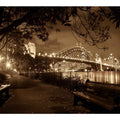 Sepia bridge canvas print with city lights and river reflections for modern office decor.