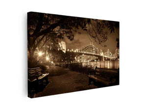 Sepia bridge canvas print with city lights and river reflections for modern office decor.