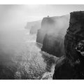 Black and white coastal cliff photography print with misty ocean for modern living room decor.