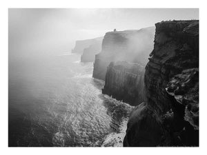 Black and white coastal cliff photography print with misty ocean for modern living room decor.