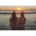 Coastal sunset beach canvas art with two women by the ocean for relaxed bedroom decor.