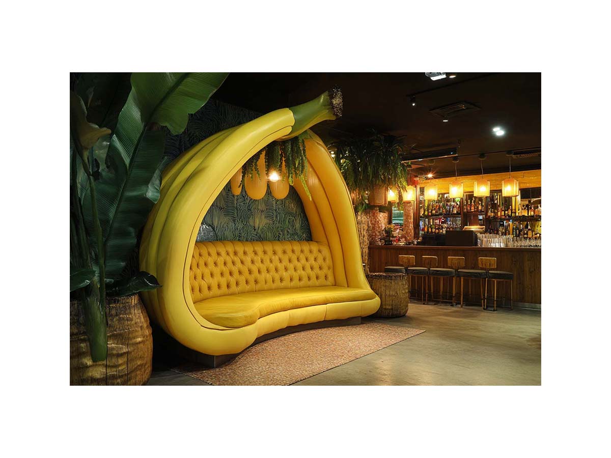 Oversized banana lounge artwork in tropical modern style for living room, home bar, and contemporary interior decor.