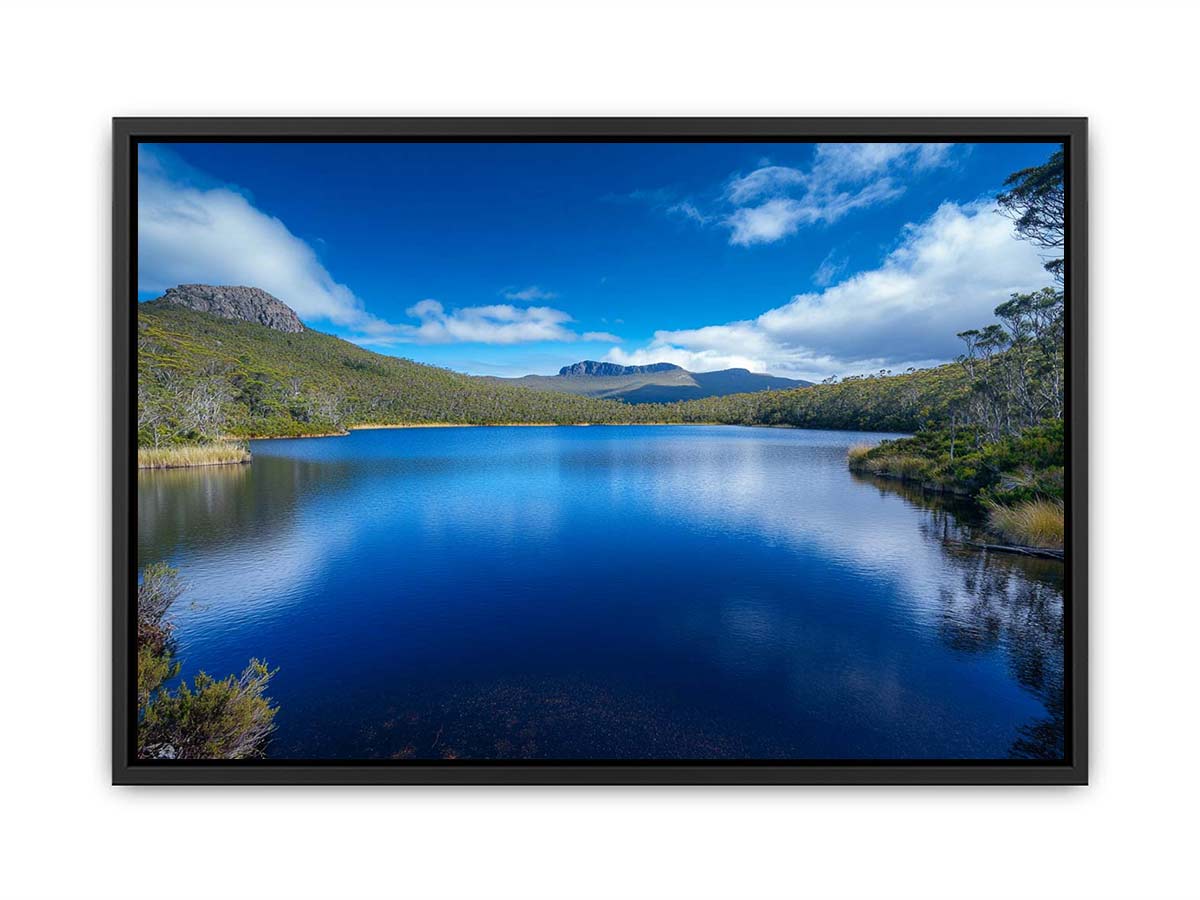 Serene mountain lake landscape with blue water and sky for modern living room wall art.