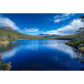 Serene mountain lake landscape with blue water and sky for modern living room wall art.