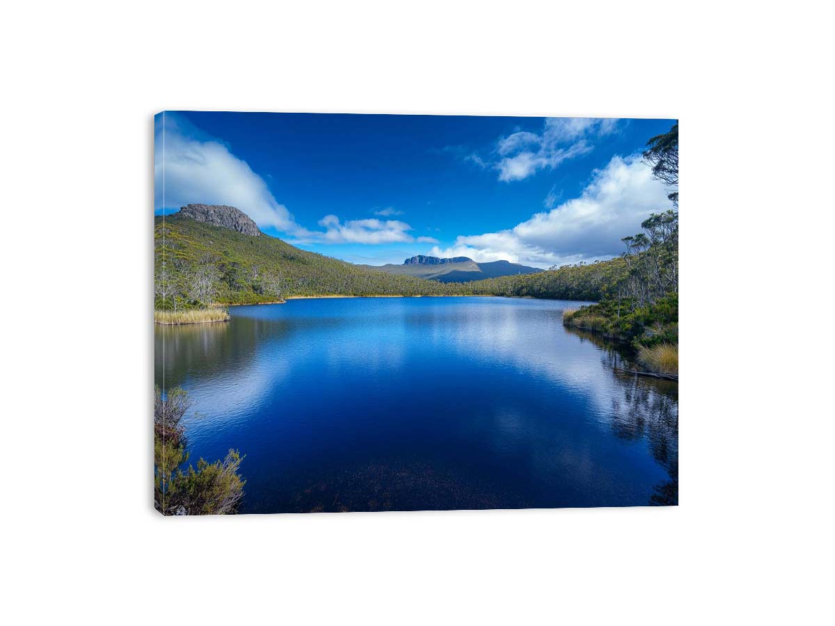 Serene mountain lake landscape with blue water and sky for modern living room wall art.